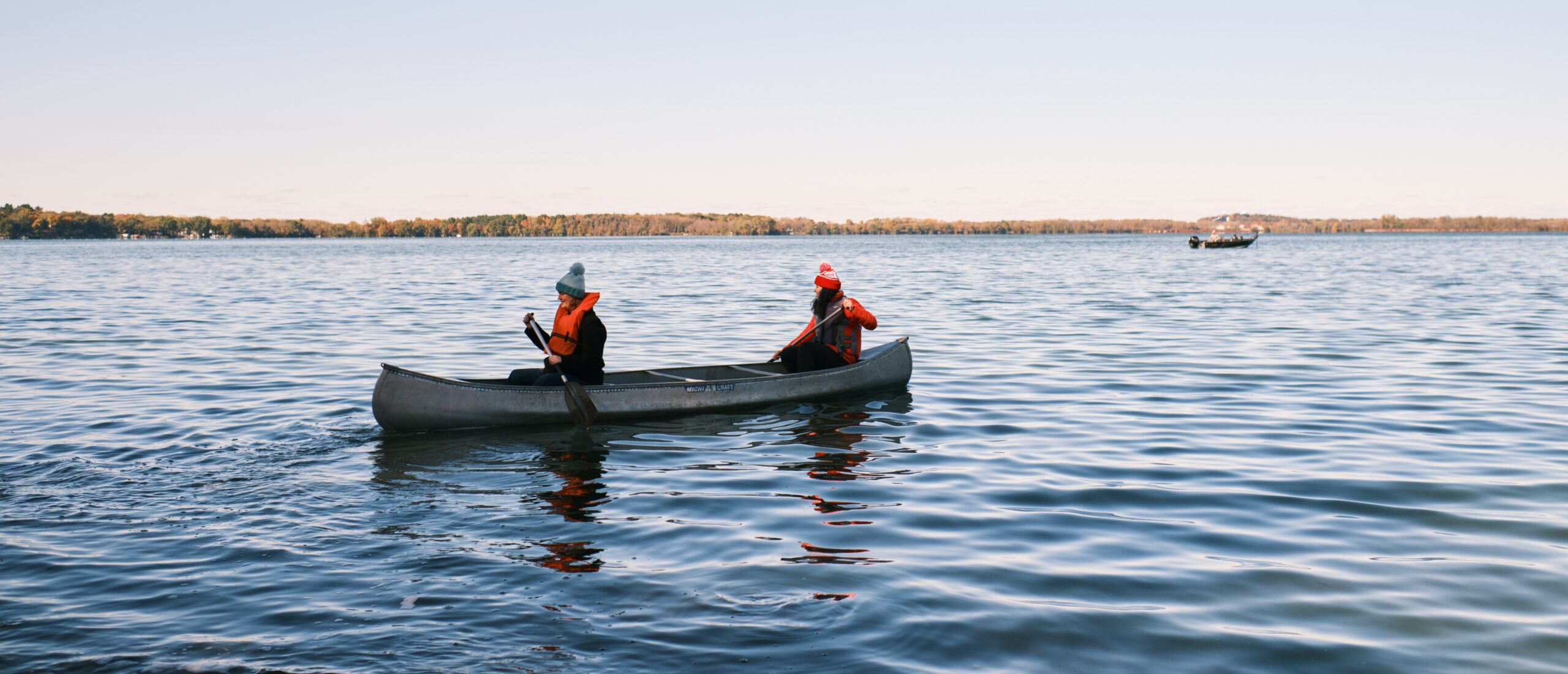 Two people rowing canoe Pres House Fall Retreat